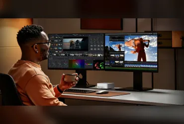 Mini PC VZMORE na biurku przed dwoma monitorami z programami do montażu wideo